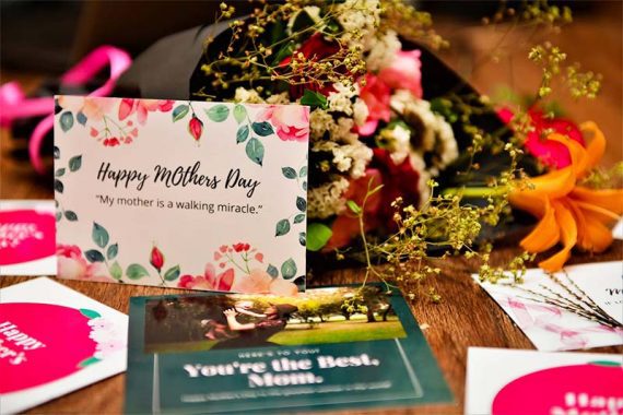 Photo of Mother's Day flowers and gift cards on a table.
