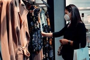Photo of a female shopping for clothes at a physical store