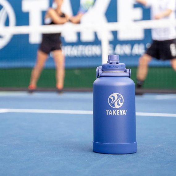 Image of a water blue water bottle on a tennis court out-of-bounds line. Source: TakeyaUSA.com