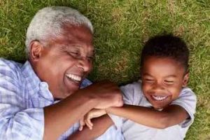 Photo of a male grandparent with a young grandson