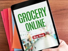 Image of a computer tablet with text "Grocery Online" on the screen