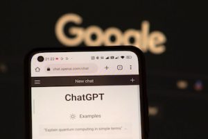 Image of ChatGPT on a smartphone with Google logo in the background