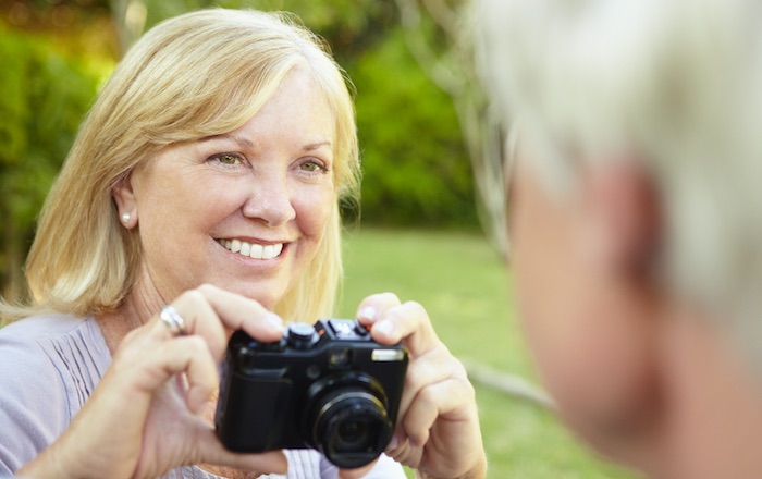 Photo of middle-aged lady holding a camera