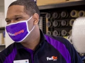 Screenshot from HappyReturns.com showing a FedEx exmployee recieving a returned item