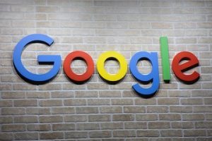 Google's logo on a brick wall of an office